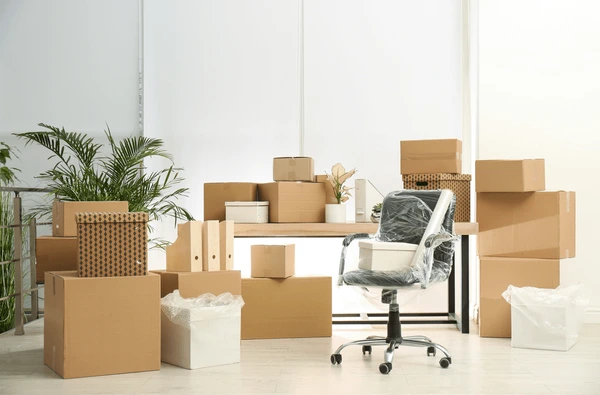 Office clearance in Essex showing packed furniture and cardboard boxes ready for removal